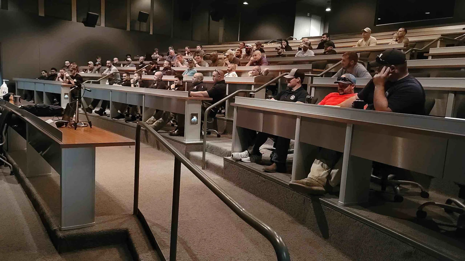 Public-safety professionals attending instruction in a tiered lecture hall